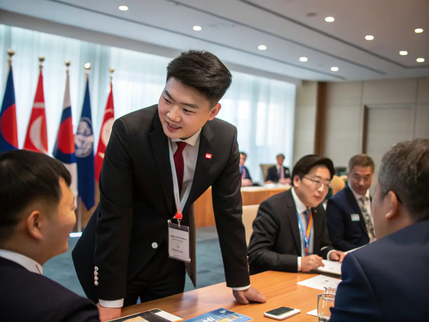 A young North Korean fellow interacting with global leaders at an international conference, exchanging ideas and building relationships. The setting is professional and inspiring, showcasing the opportunities provided by the Liberty Leaders Assembly.